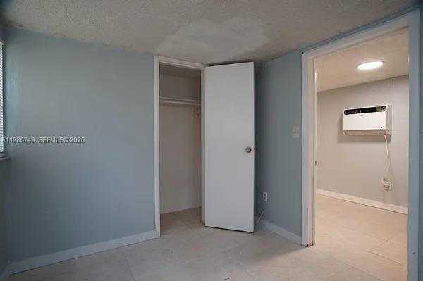 a view of kitchen island with stainless steel appliances wooden floor