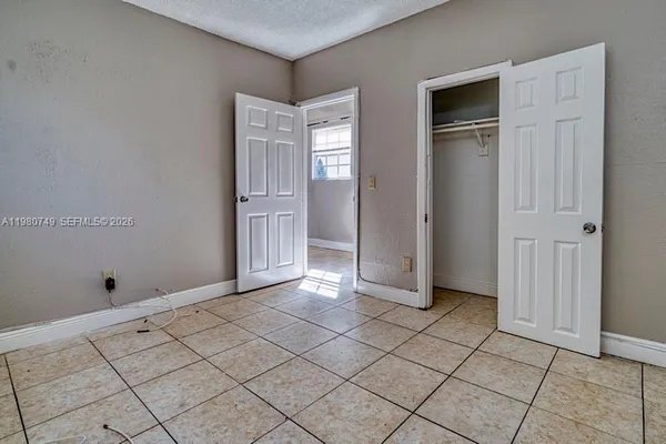 a view of a kitchen with a refrigerator and a stove top oven