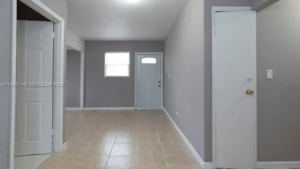 an empty room with windows and closet