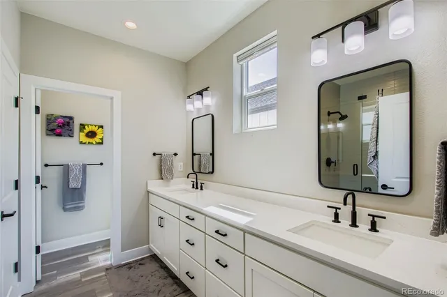 a bathroom with a double vanity sink and a mirror