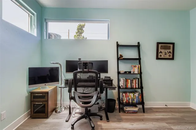 a view of a workspace with furniture and a book shelf