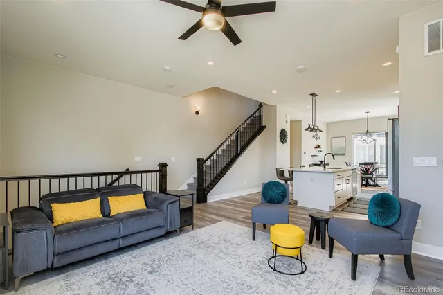 a living room with furniture and wooden floor