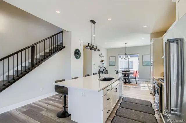 a kitchen with sink cabinets and refrigerator