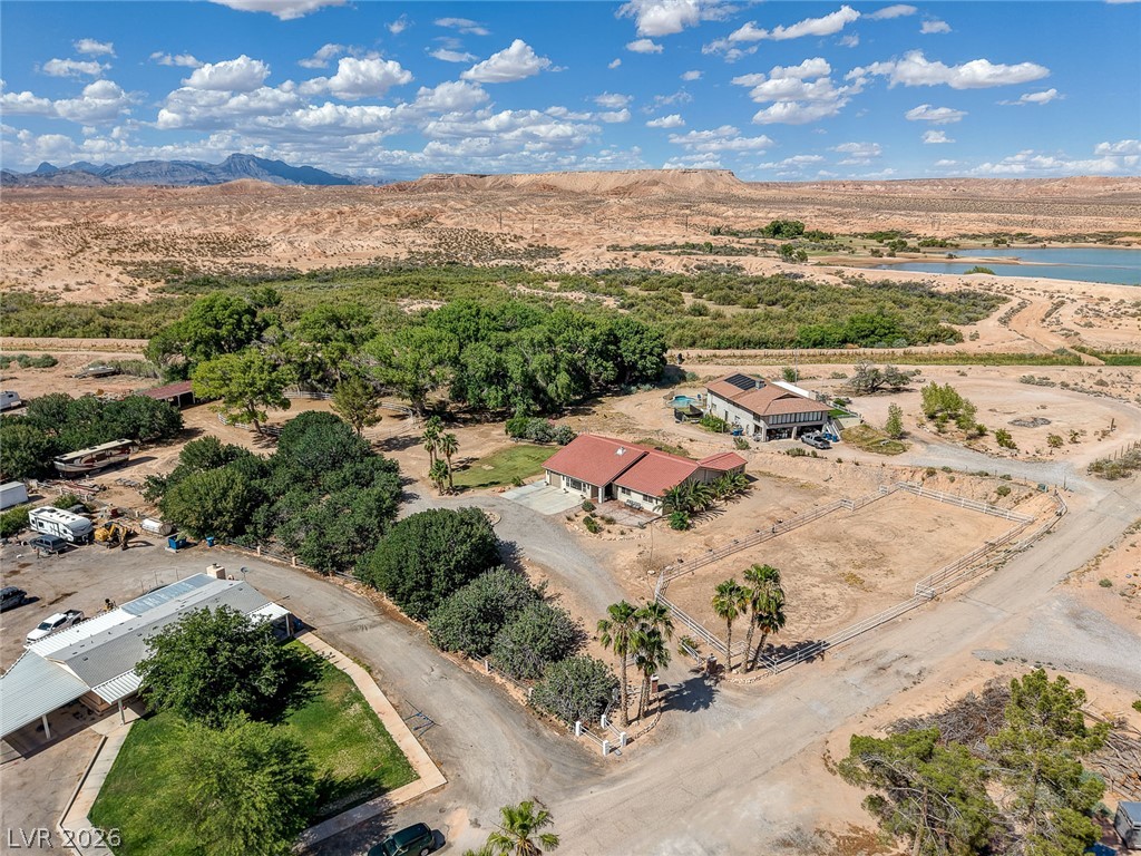 1950 Bowman Road Logandale, NV 89021 - Photo 68 of 81 An aerial panorama reveals desert vistas, verdant trees, and tranquil water, creating a secluded oasis.