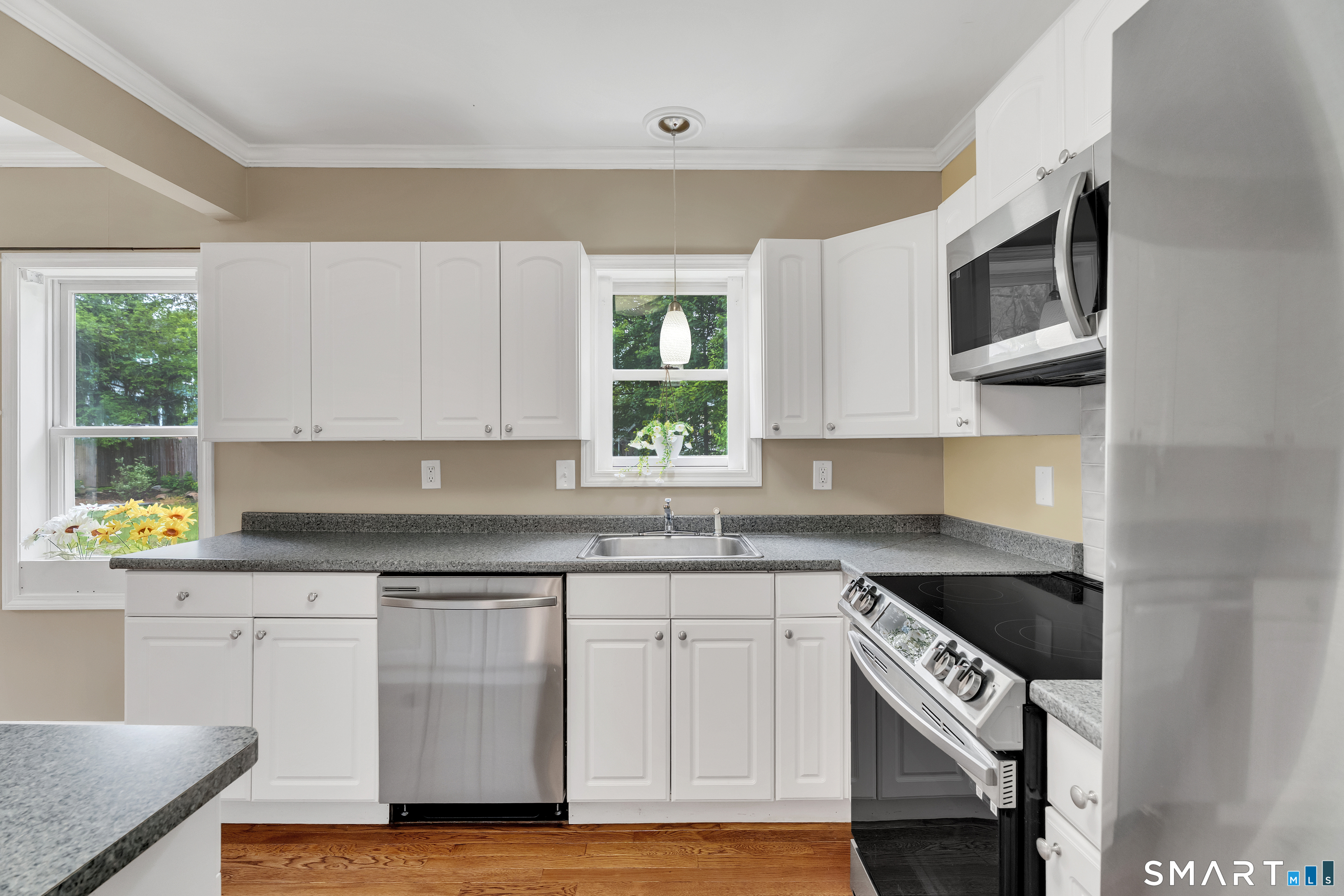 75 Summit Street Norwich, CT 06360 - Photo 20 of 40 a kitchen with stainless steel appliances granite countertop a stove a sink and a microwave