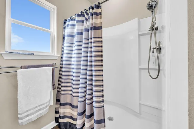 a bathroom with a shower and a sink