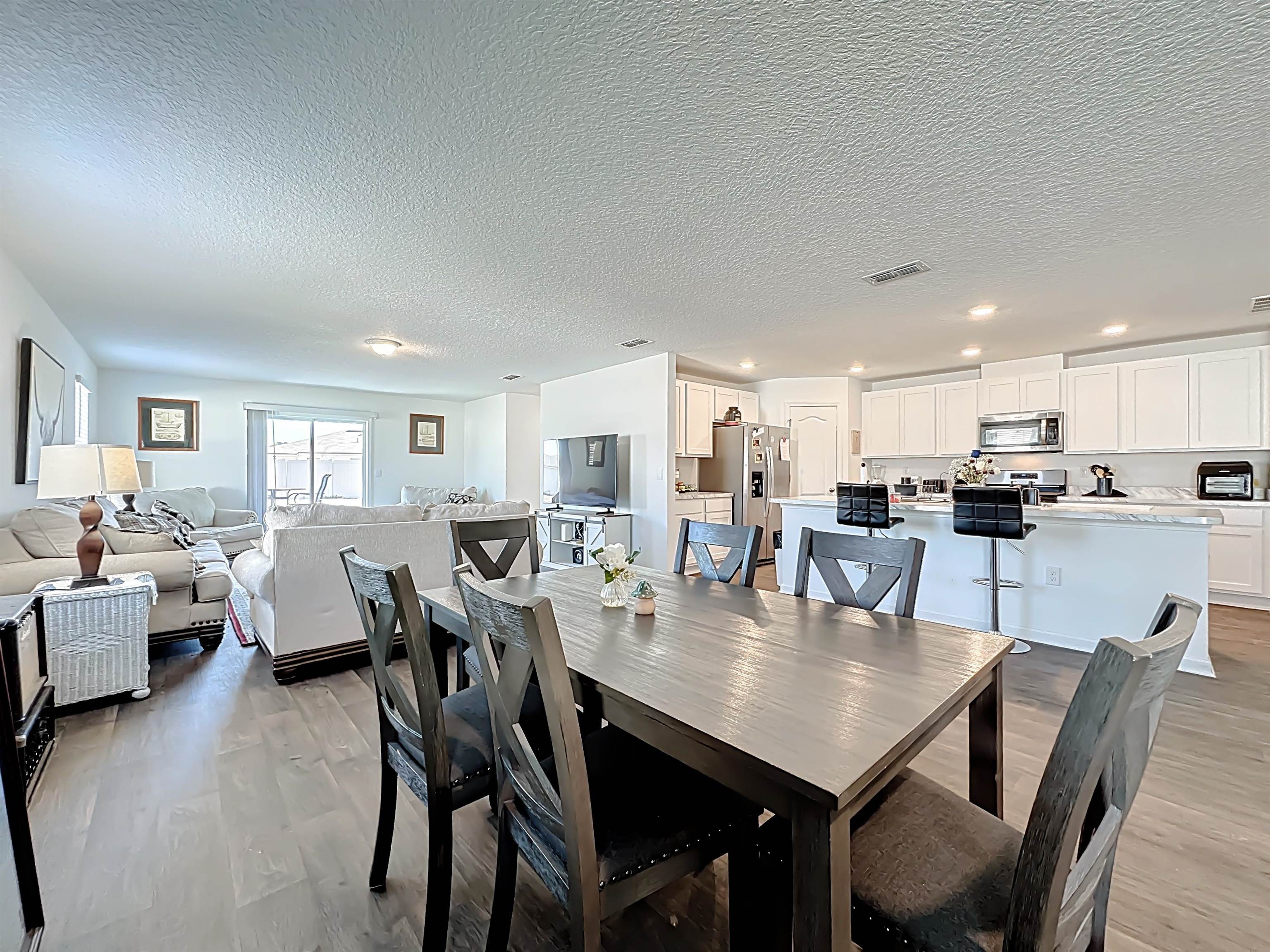 16 Encanto Way Street St. Augustine, FL 32084 - Photo 11 of 56 Dining space with a textured ceiling and wood finished floors