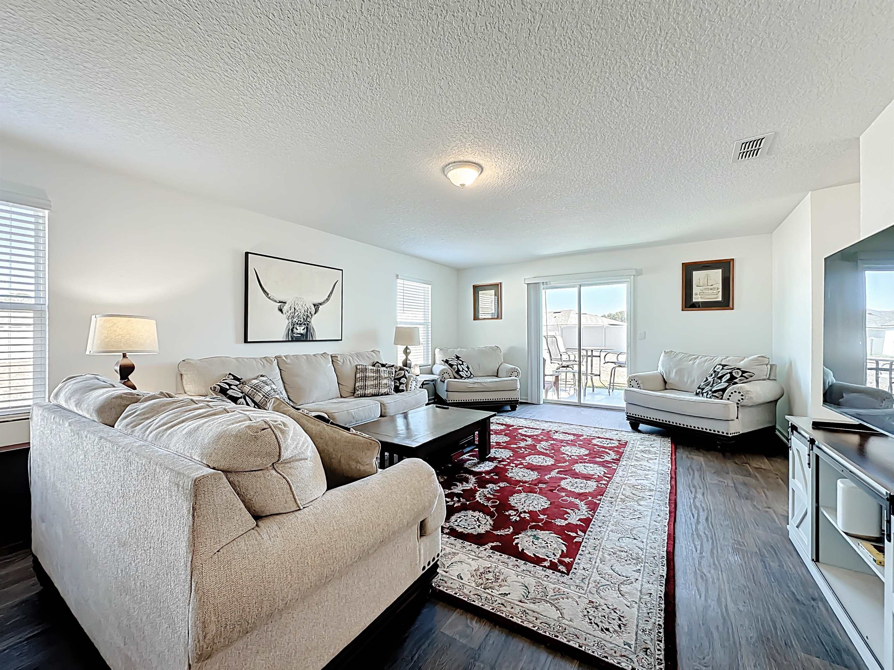 16 Encanto Way Street St. Augustine, FL 32084 - Photo 17 of 56 Living area featuring a textured ceiling and dark wood-type flooring