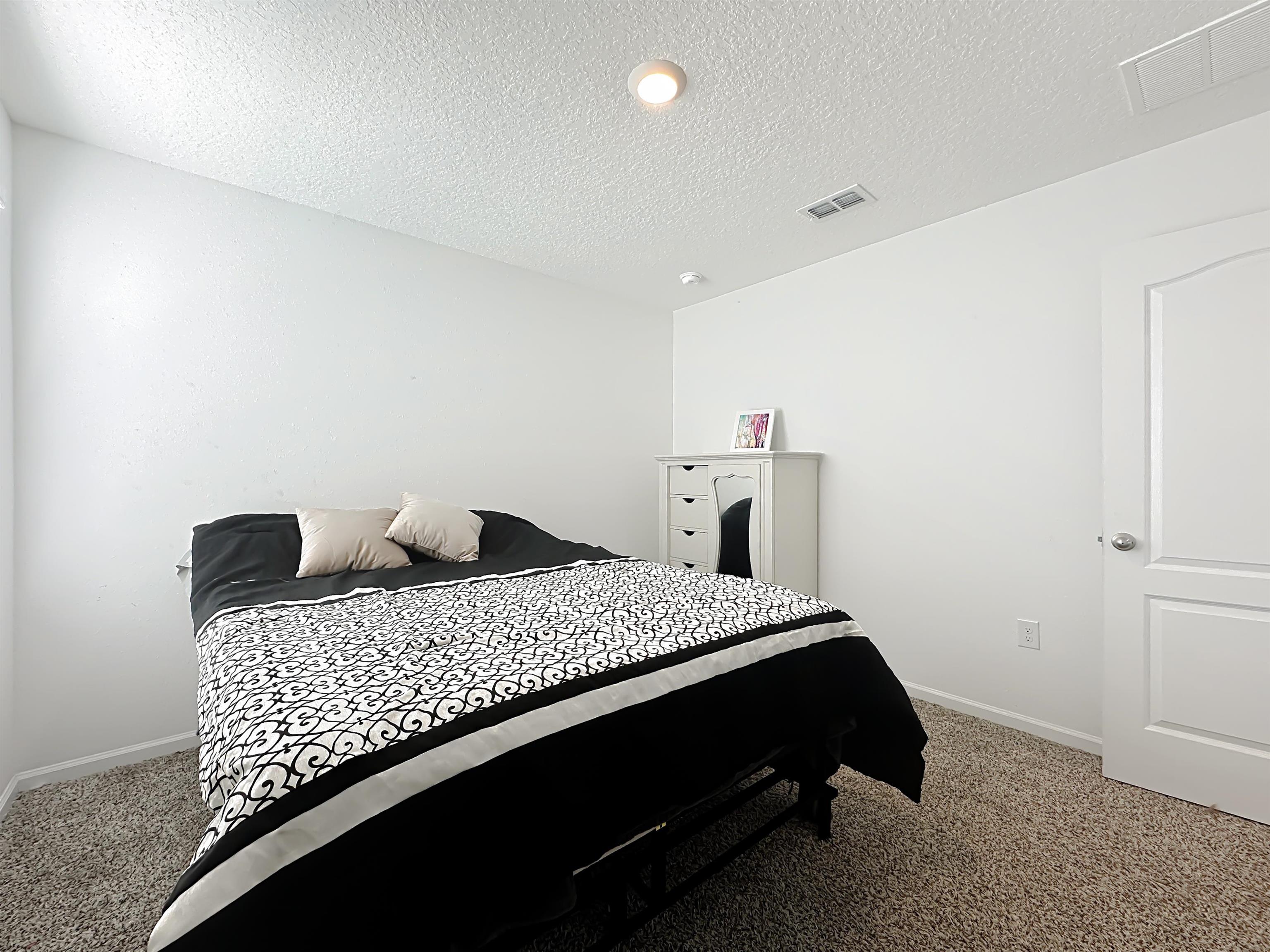16 Encanto Way Street St. Augustine, FL 32084 - Photo 30 of 56 Bedroom with light carpet and a textured ceiling