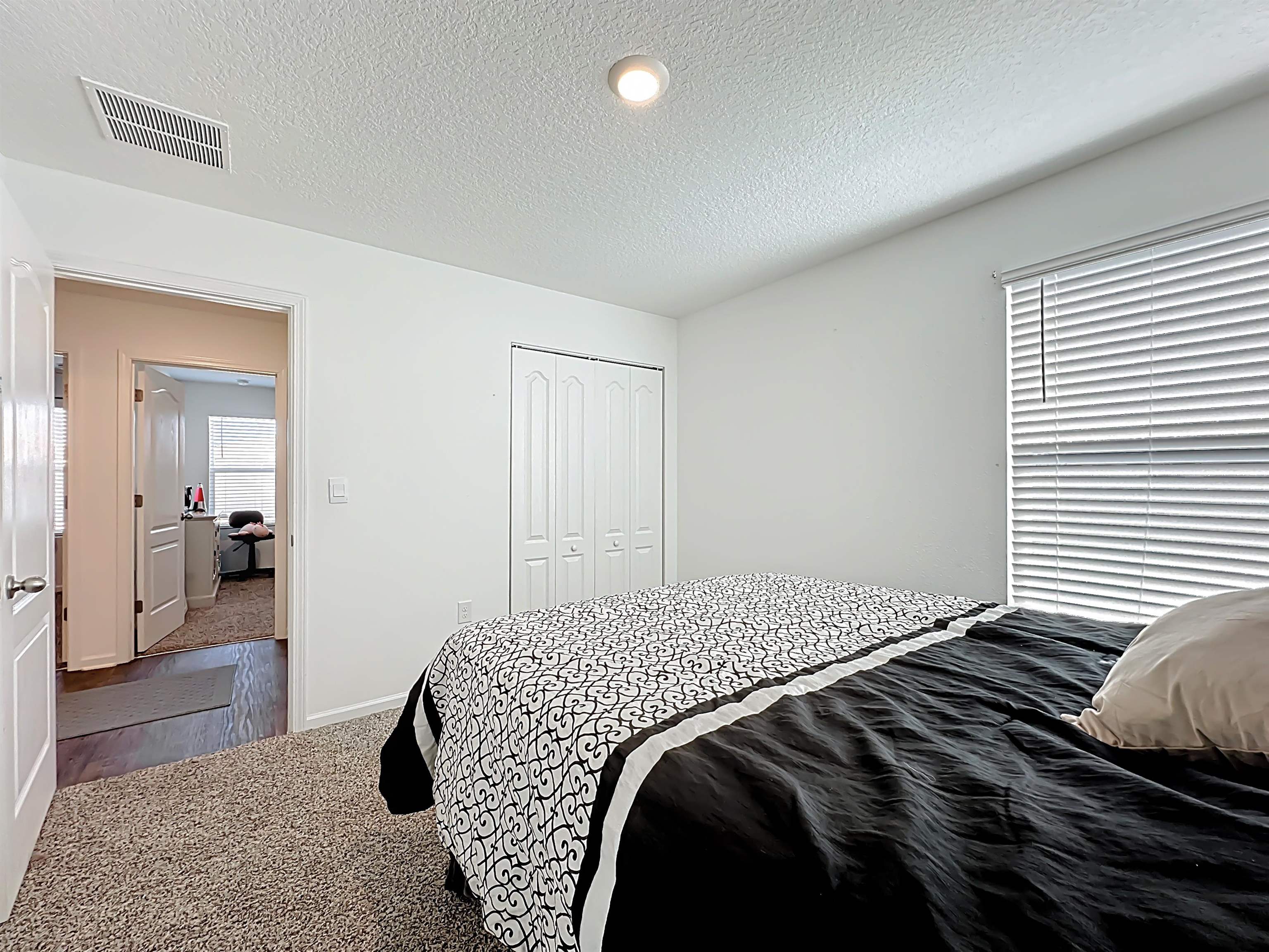 16 Encanto Way Street St. Augustine, FL 32084 - Photo 31 of 56 Bedroom with carpet floors, a textured ceiling, and a closet