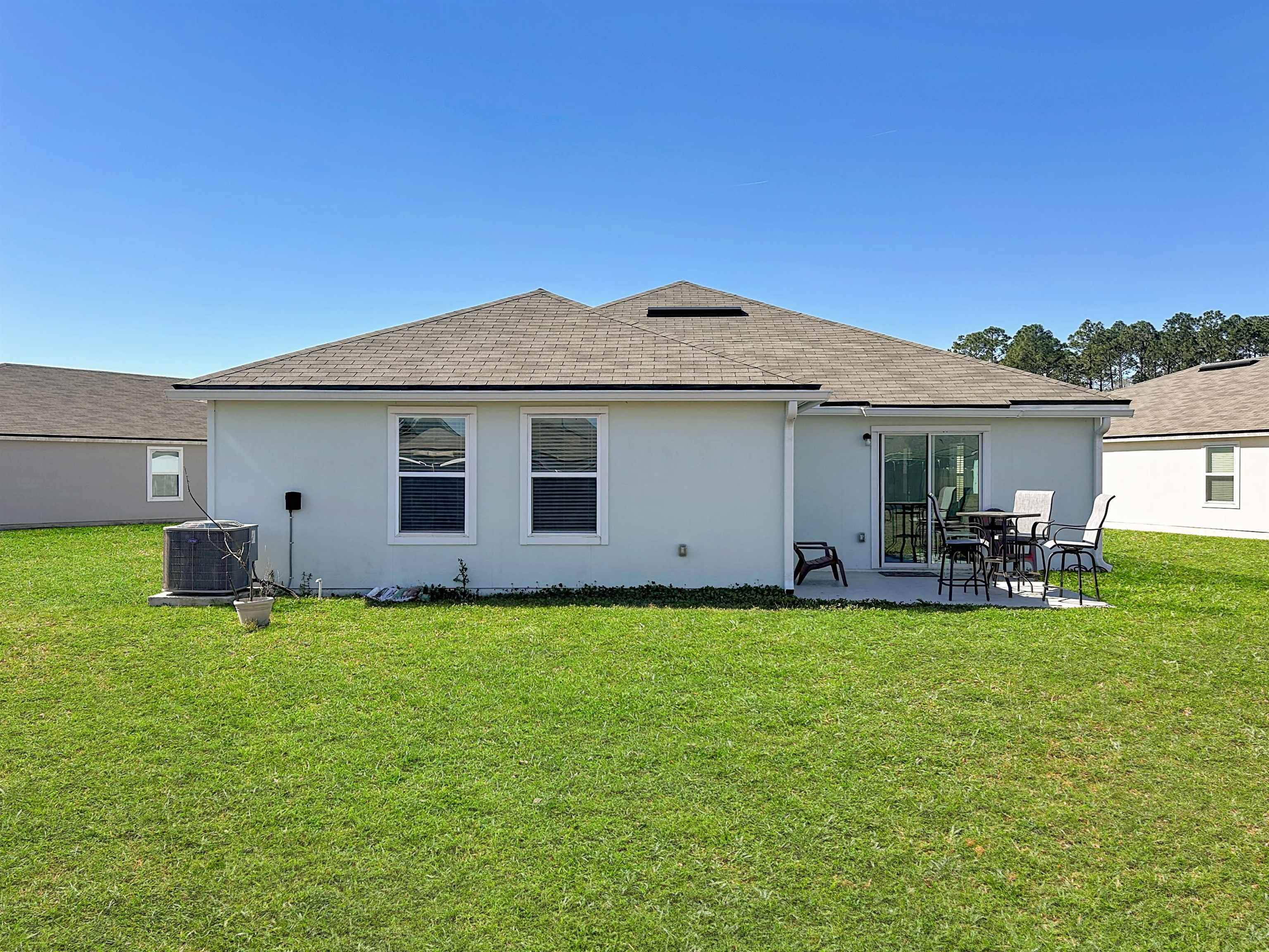 16 Encanto Way Street St. Augustine, FL 32084 - Photo 36 of 56 Rear view of property with a yard, stucco siding, and a patio area