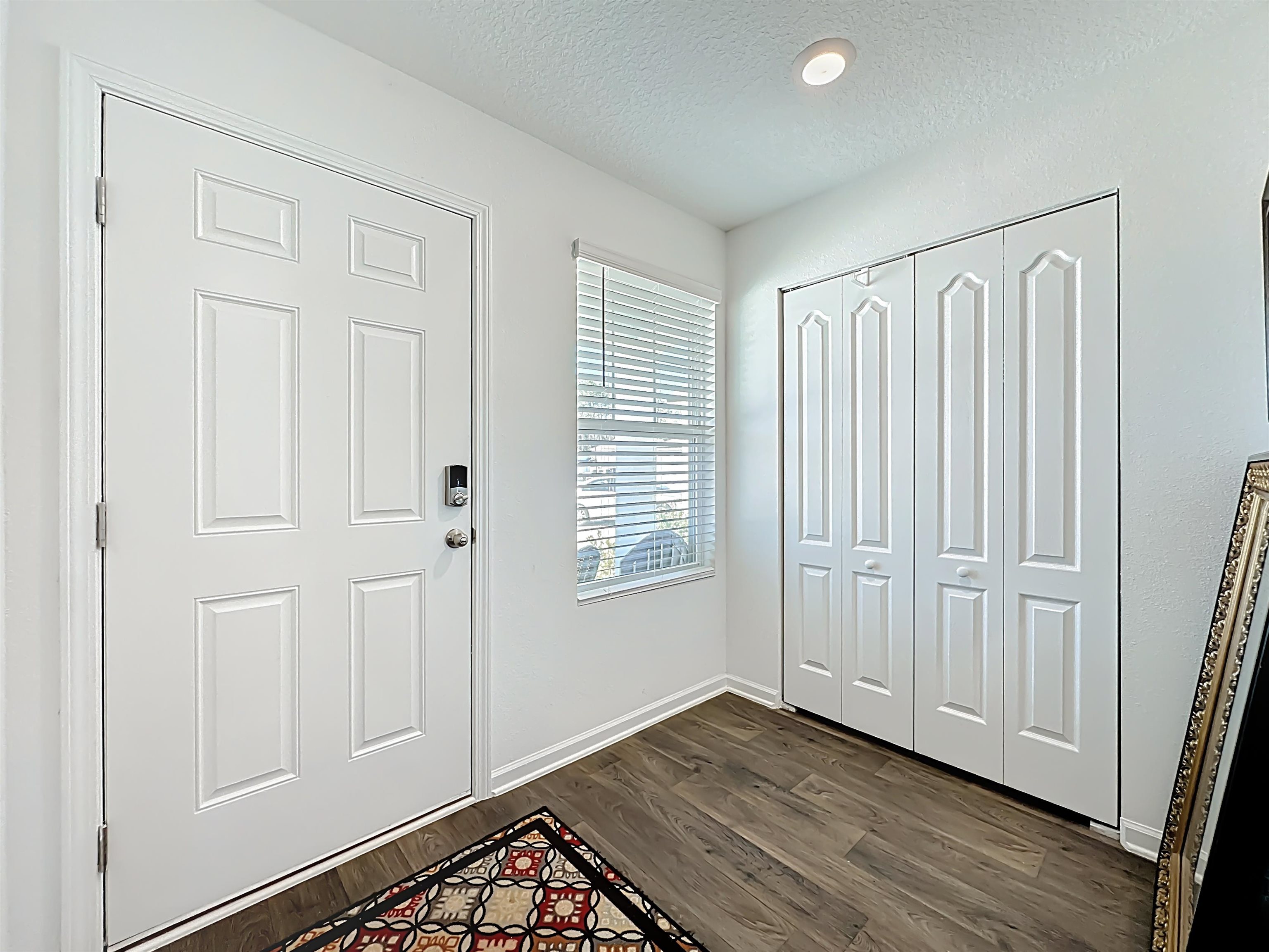 16 Encanto Way Street St. Augustine, FL 32084 - Photo 8 of 56 Entrance foyer with a textured ceiling and dark wood-style floors