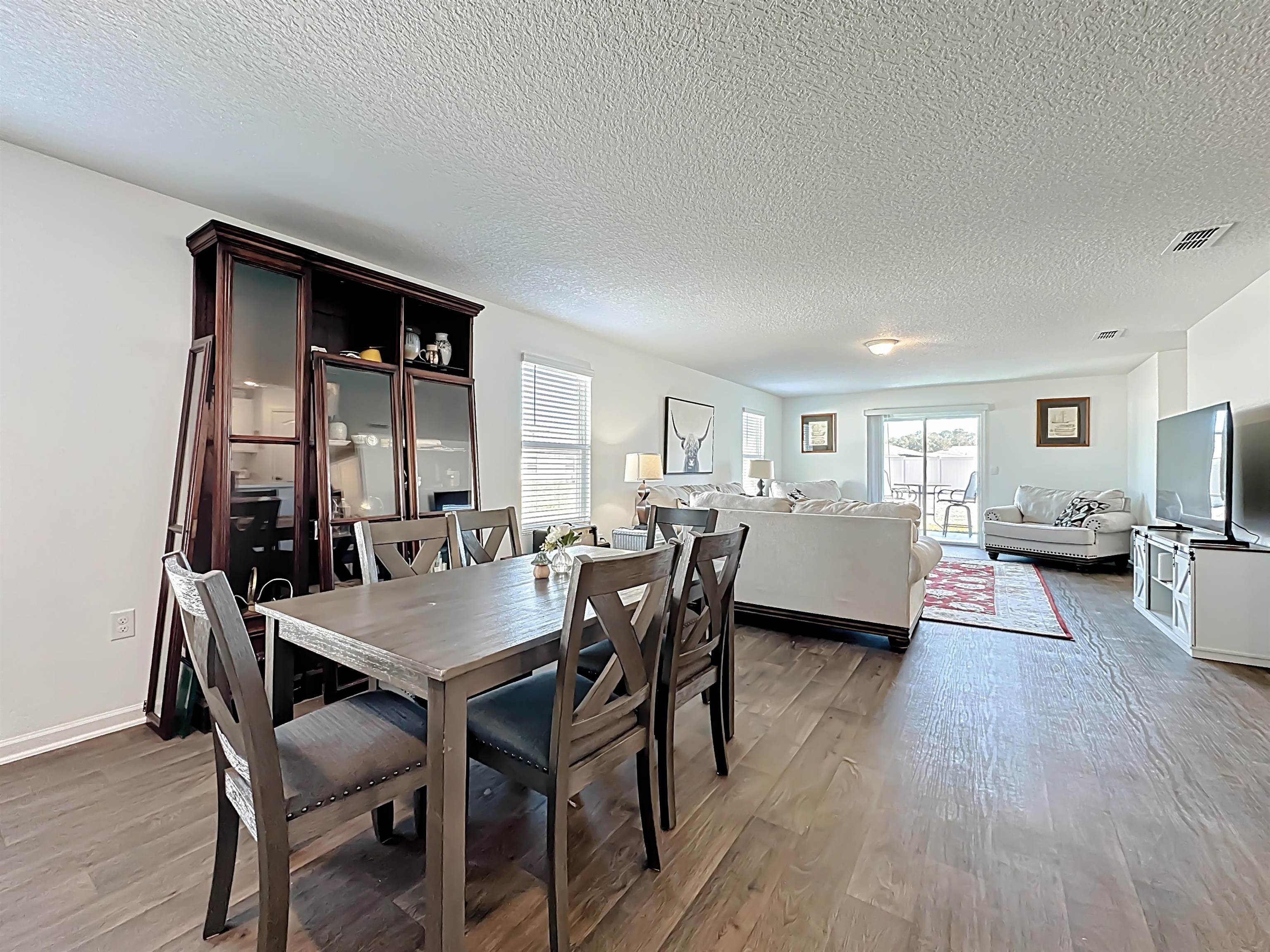 16 Encanto Way Street St. Augustine, FL 32084 - Photo 10 of 56 Dining area featuring a textured ceiling and light wood-style flooring
