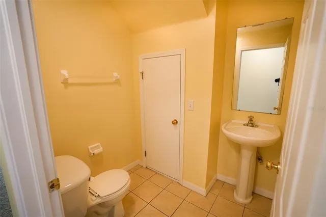 a bathroom with a sink a toilet a mirror and shower