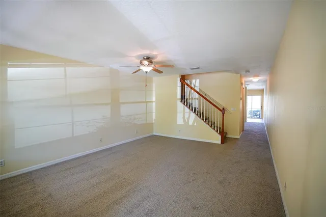 a view of an empty room with stairs