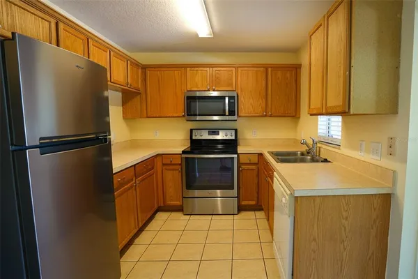 a kitchen with a refrigerator sink and microwave