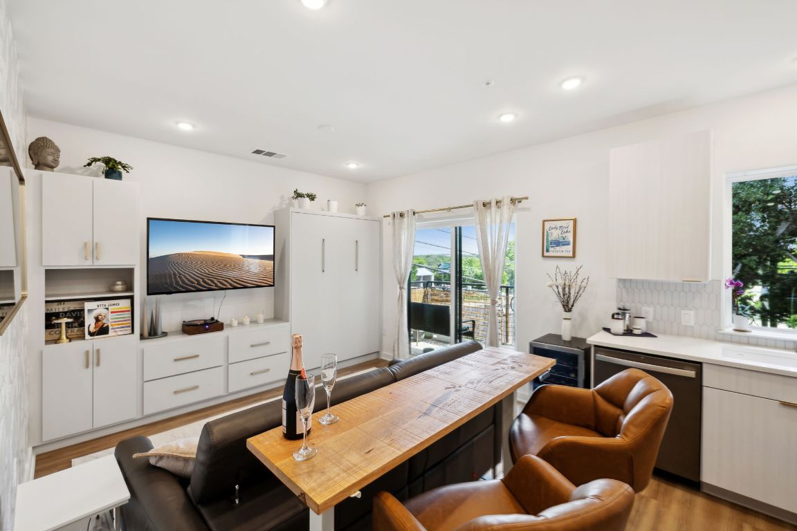 4802 South Congress Avenue, Unit 215 Austin, TX 78745 - Photo 1 of 32 a living room with furniture and a flat screen tv