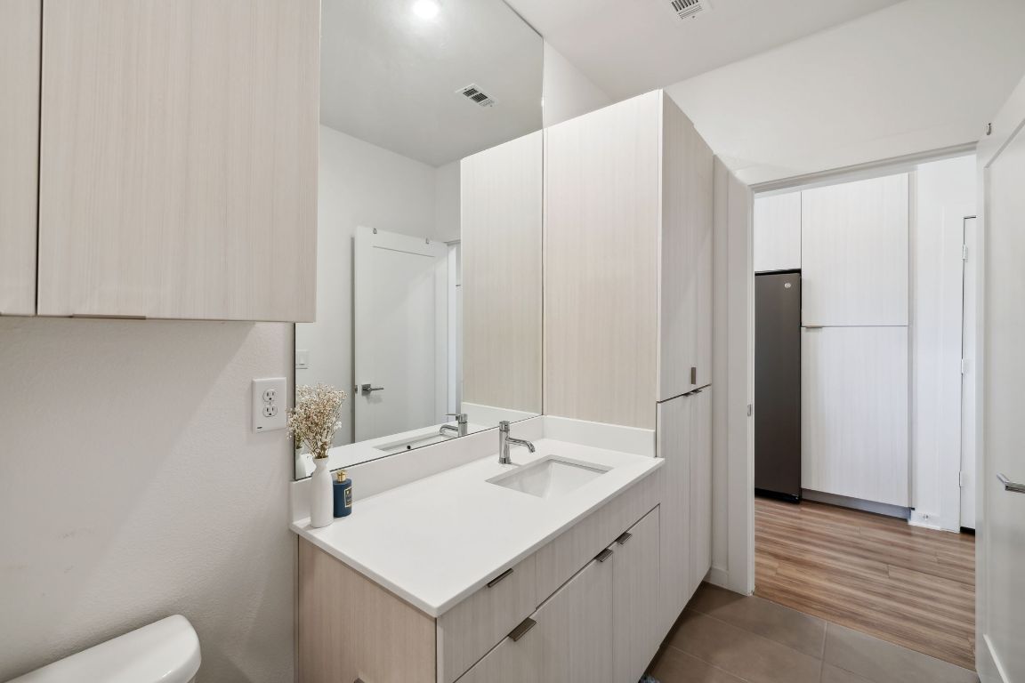4802 South Congress Avenue, Unit 215 Austin, TX 78745 - Photo 12 of 32 a bathroom with a sink toilet and shower