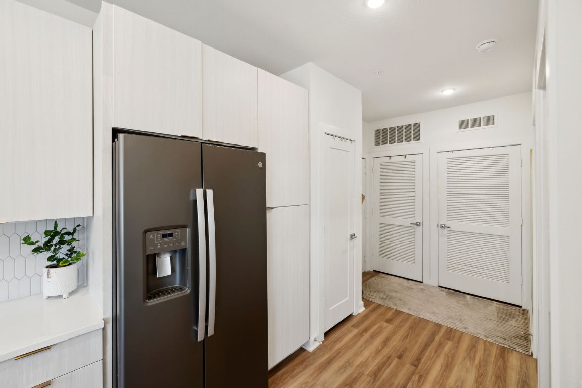 4802 South Congress Avenue, Unit 215 Austin, TX 78745 - Photo 15 of 32 a view of a kitchen with a refrigerator and a stove