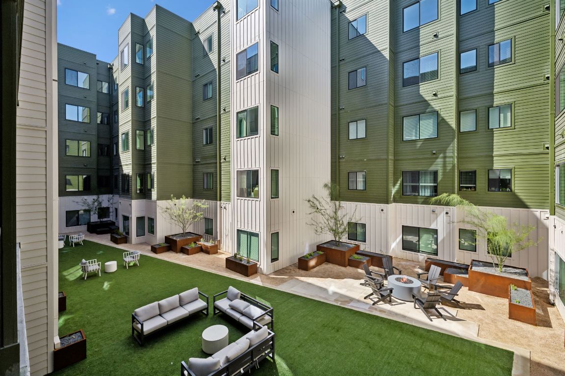 4802 South Congress Avenue, Unit 215 Austin, TX 78745 - Photo 23 of 32 a view of a patio with couches table and chairs and potted plants