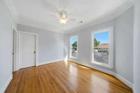 a spacious bedroom with a large bed and a chandelier
