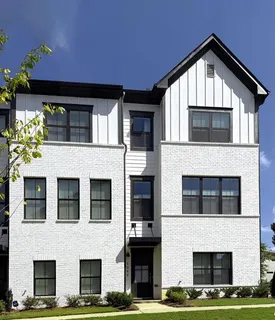 a front view of a house with large windows