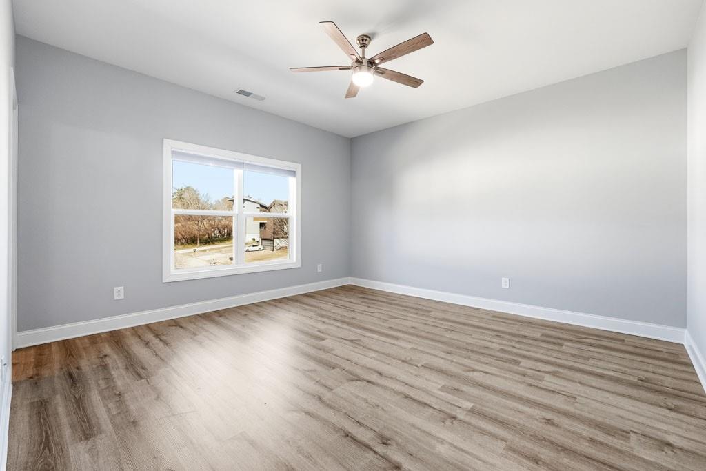 1363 Pavilion Street Southeast Atlanta, GA 30316 - Photo 14 of 25 an empty room with window and wooden floor
