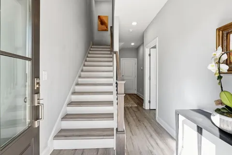 a view of entryway and hall with wooden floor