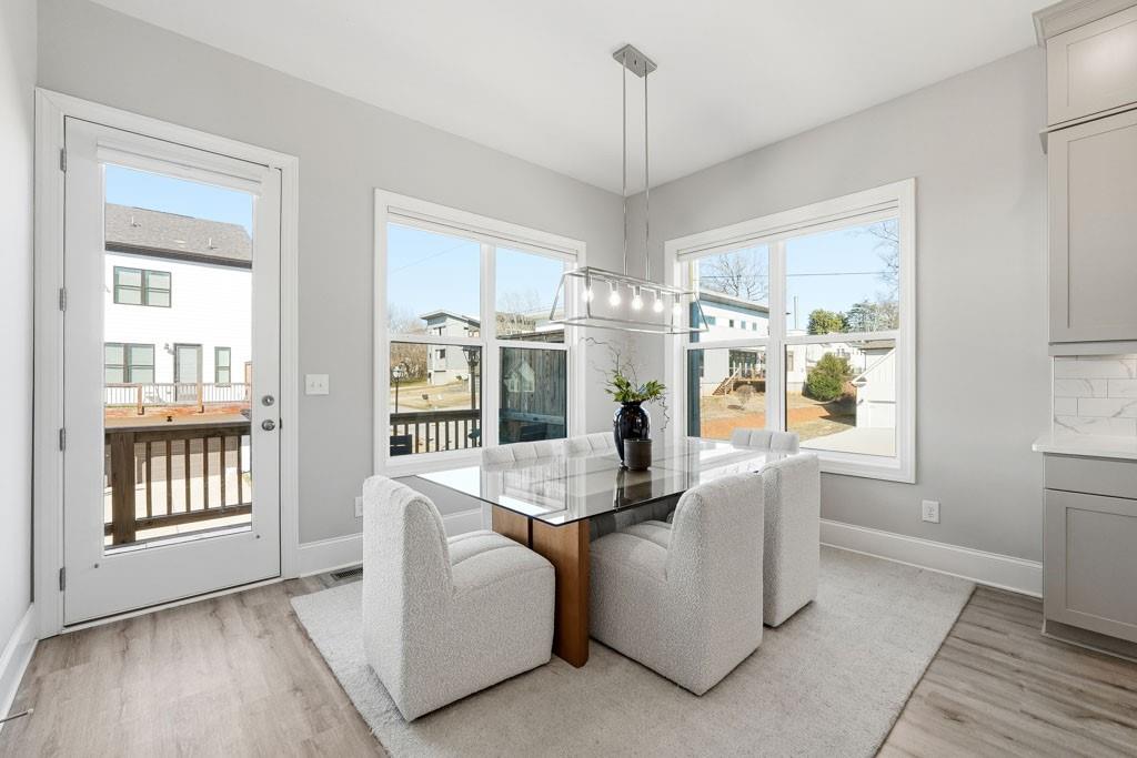 1363 Pavilion Street Southeast Atlanta, GA 30316 - Photo 9 of 25 a view of a dining room with furniture large windows and wooden floor