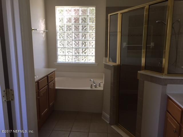 2120 West Quay Road St. Augustine, FL 32092 - Photo 12 of 12 a bathroom with a bathtub and a window