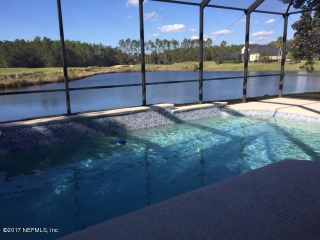 2120 West Quay Road St. Augustine, FL 32092 - Photo 2 of 12 a view of a yard with a floor to ceiling window
