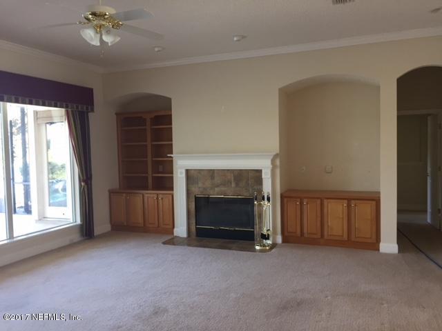 2120 West Quay Road St. Augustine, FL 32092 - Photo 6 of 12 a view of an empty room with window and fireplace