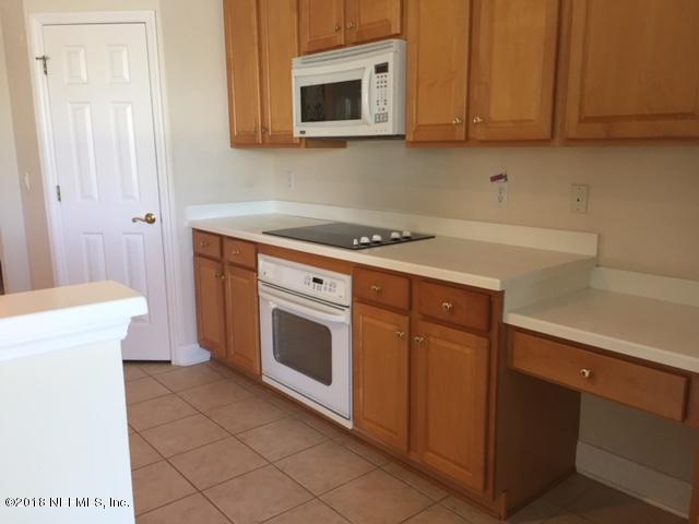 2120 West Quay Road St. Augustine, FL 32092 - Photo 9 of 12 a kitchen with a stove and a microwave