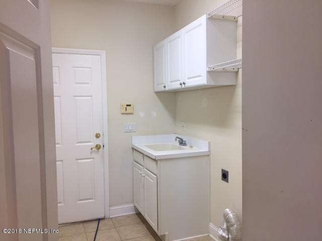2120 West Quay Road St. Augustine, FL 32092 - Photo 10 of 12 a utility room with cabinets washer and dryer