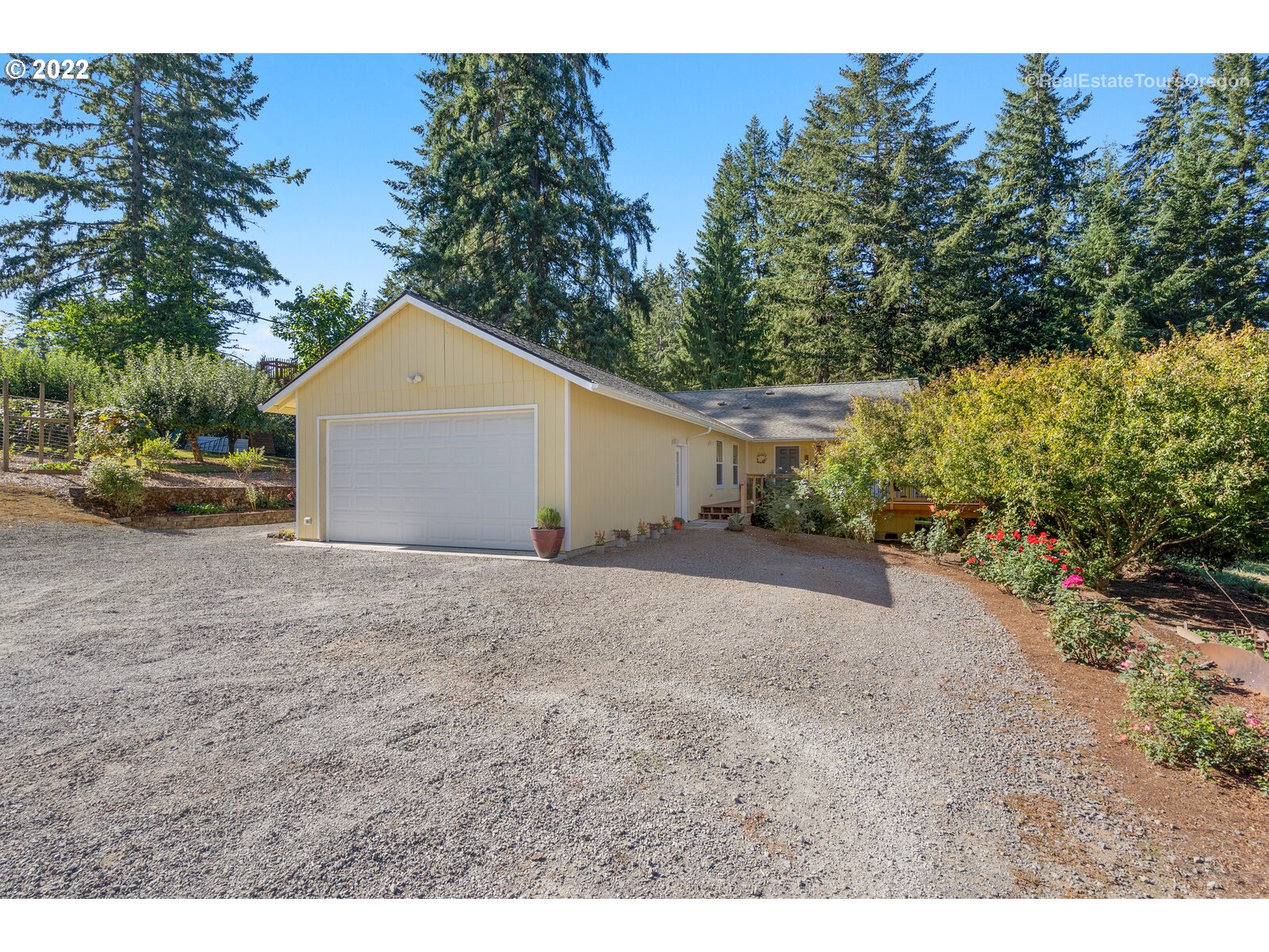 a view of a house with a yard and garage