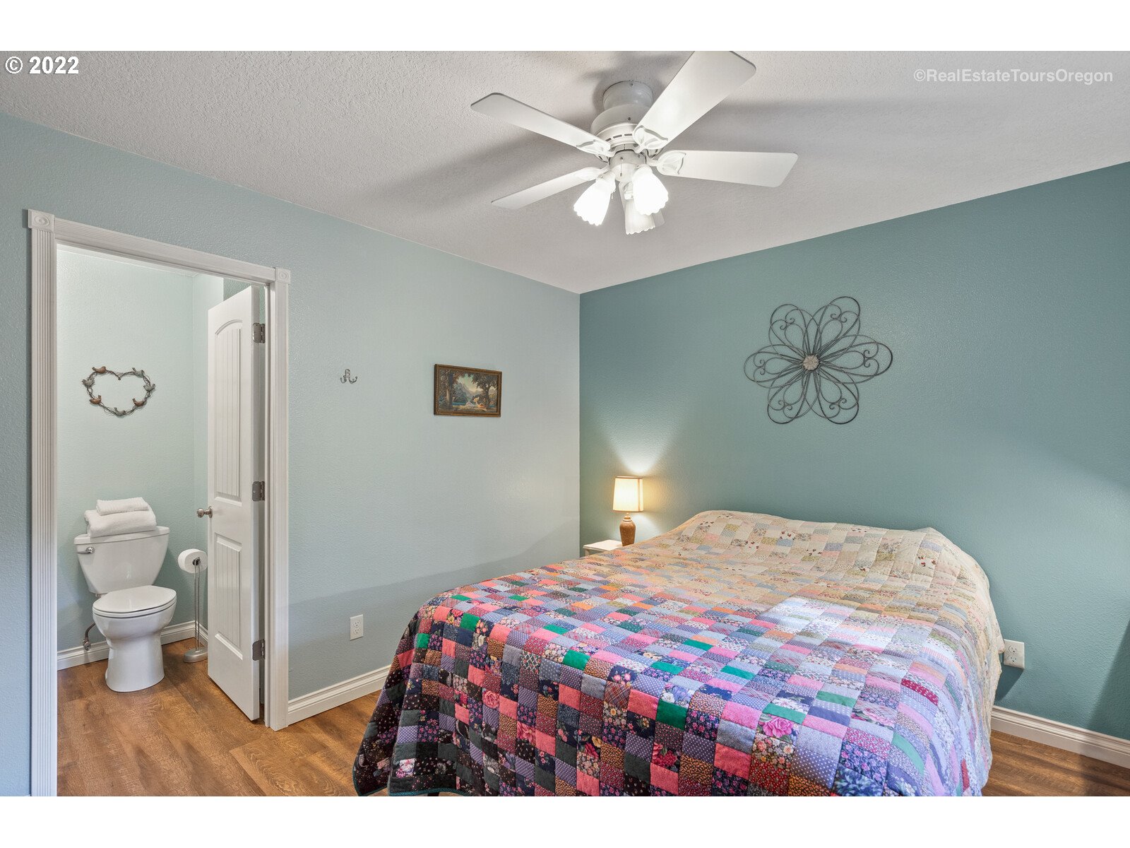 12715 South Casto Road Oregon City, OR 97045 - Photo 15 of 32 a bedroom with a large bed and a chandelier