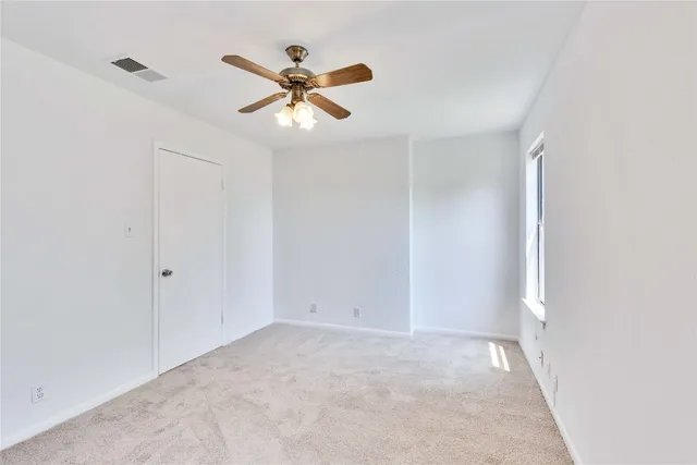 a bathroom with a granite countertop toilet sink and mirror