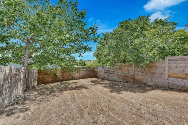 a view of a house with a tree beside it