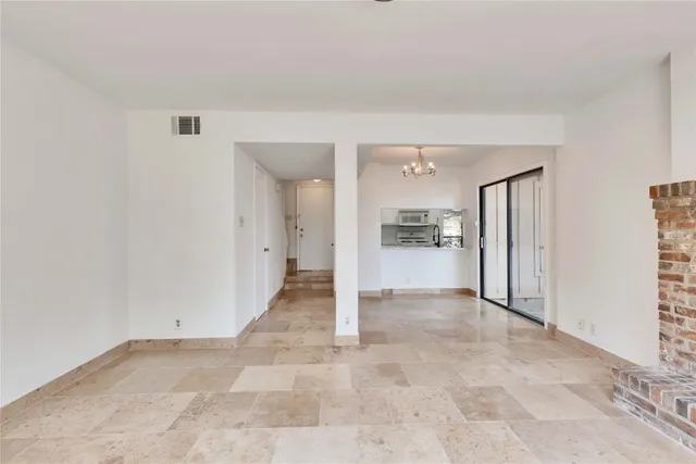 a view of kitchen and refrigerator
