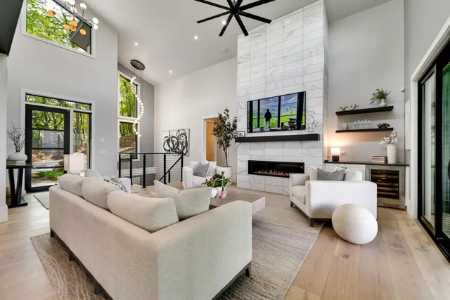 a kitchen with stainless steel appliances granite countertop a stove a sink dishwasher and a dining table with wooden floor