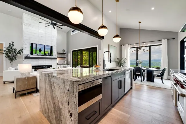 a bed sitting in a spacious bedroom next to a window