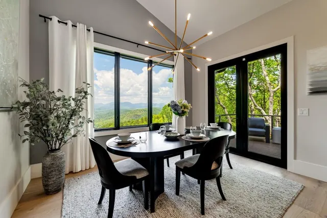 a bedroom with a bed a chandelier and a large window