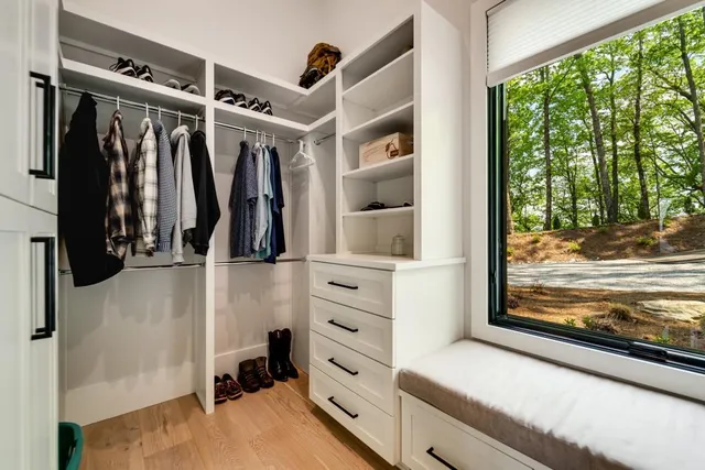 a spacious bedroom with a large bed and a chandelier fan