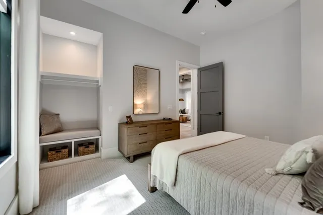 a bathroom with a sink a toilet a mirror and shower