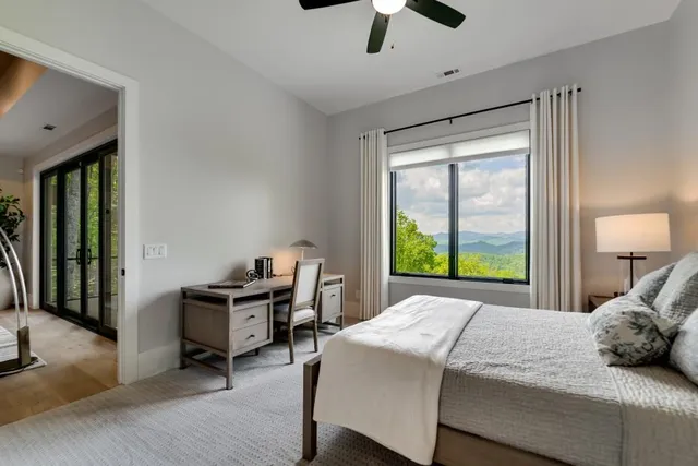 a view of a lush green hillside and a building in the background