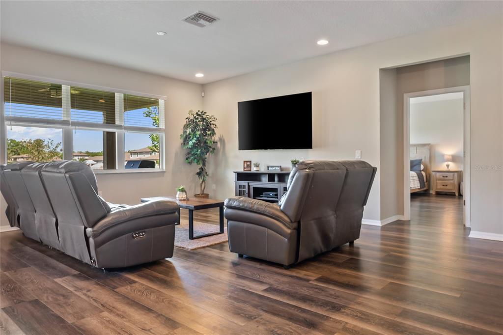 18428 Malinche Loop Spring Hill, FL 34610 - Photo 16 of 62 a living room with furniture and a flat screen tv