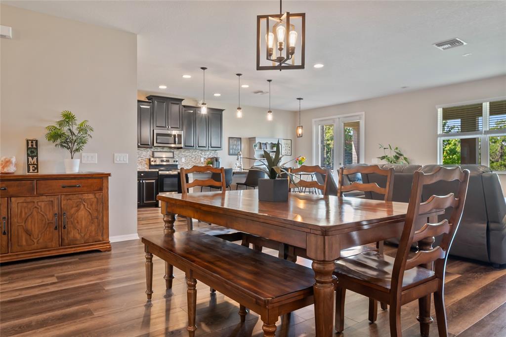 18428 Malinche Loop Spring Hill, FL 34610 - Photo 18 of 62 a dining room with furniture and wooden floor