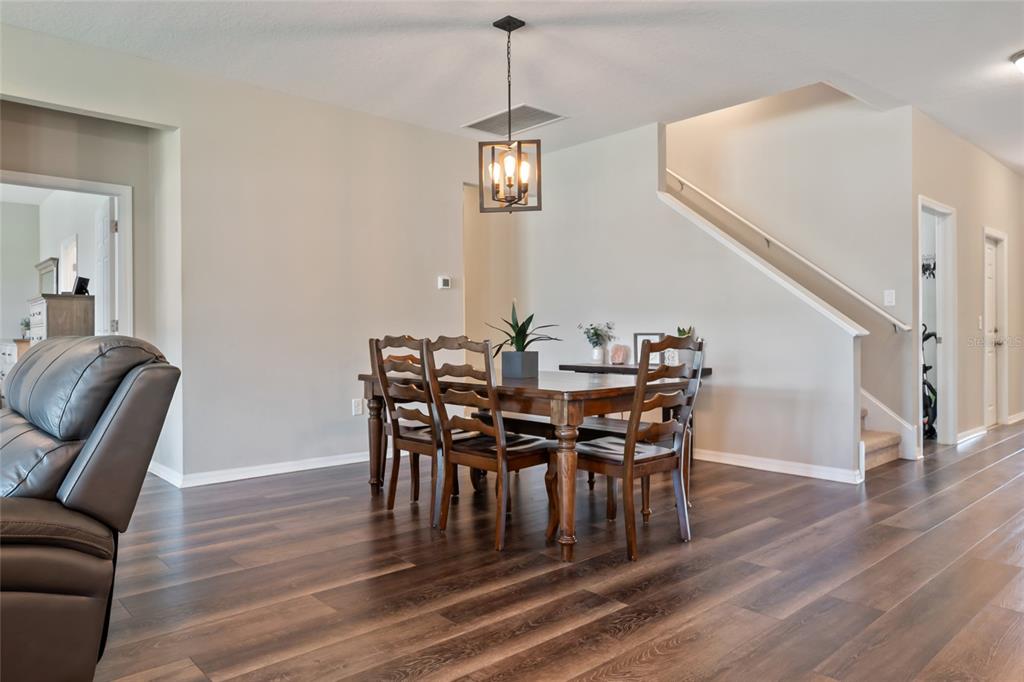 18428 Malinche Loop Spring Hill, FL 34610 - Photo 19 of 62 a view of a dining room with furniture wooden floor and chandelier
