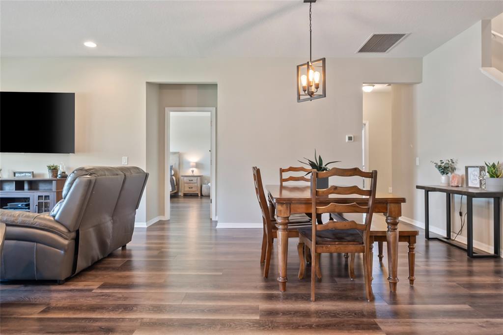18428 Malinche Loop Spring Hill, FL 34610 - Photo 20 of 62 a view of a dining room with furniture window and wooden floor