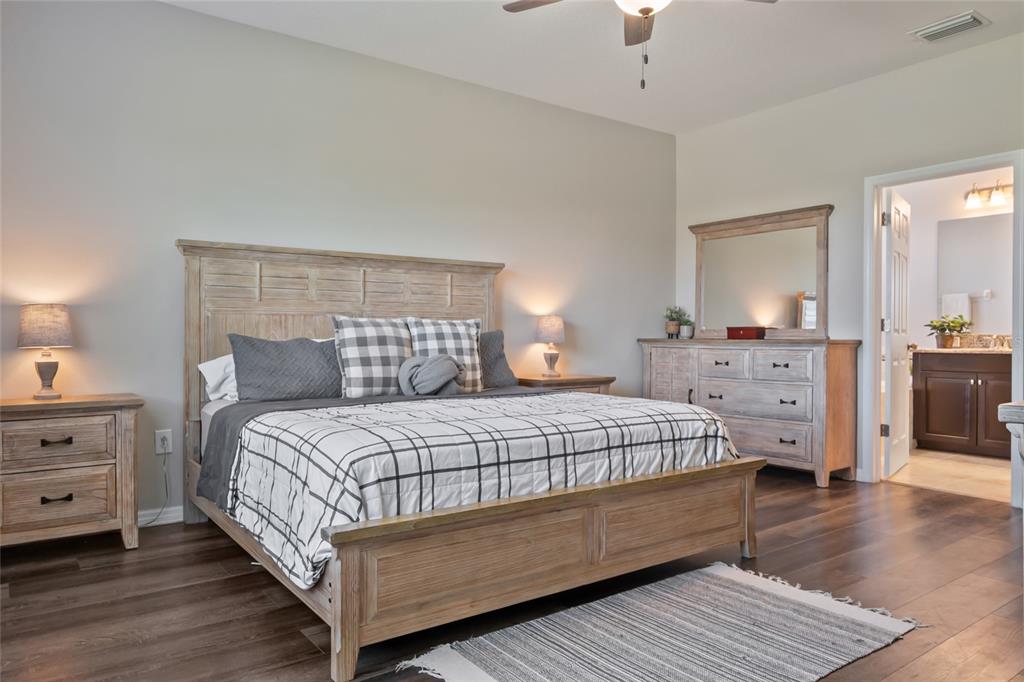 18428 Malinche Loop Spring Hill, FL 34610 - Photo 24 of 62 a bedroom with a bed and a dresser